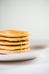 Stack of Small pancakes in syrup