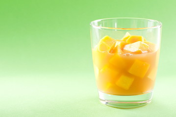 cubes of mango pulp isolated on a green background