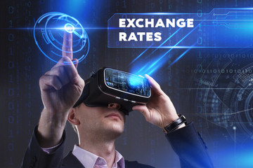 Business, Technology, Internet and network concept. Young businessman working in virtual reality glasses sees the inscription: Exchange rates
