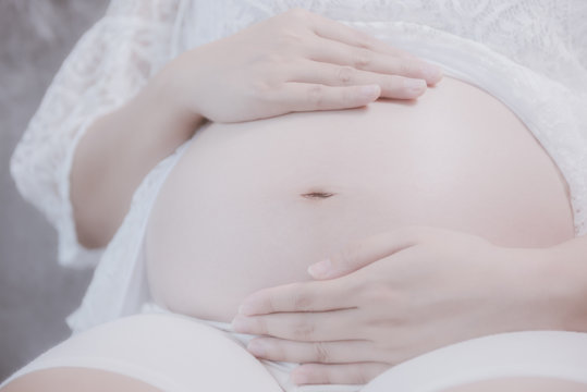 pregnant woman sitting on sofa close up