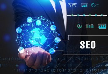 Business, Technology, Internet and network concept. Young businessman working on a virtual screen of the future and sees the inscription: SEO