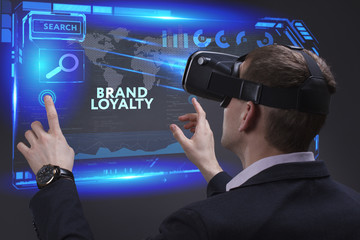 Business, Technology, Internet and network concept. Young businessman working on a virtual screen of the future and sees the inscription: Brand loyalty