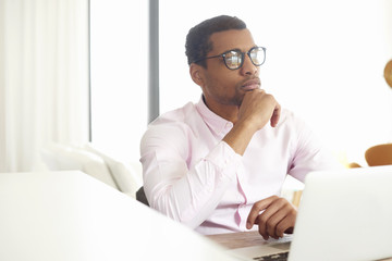 Home office is a good idea. Afro American businessman working online 