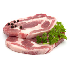 Raw pork neck chop meat with parsley herb leaves and peppercorn spices garnish isolated on white background cutout