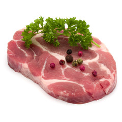 Raw pork neck chop meat with parsley herb leaves and peppercorn spices garnish isolated on white background cutout