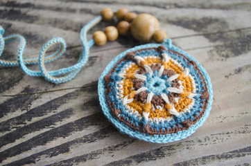 Handmade accessories in ethnic style. Crochet homemade things. Crochet pattern. Handicraft manufacturing