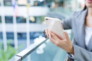 Businesswoman sending sms on cellphone