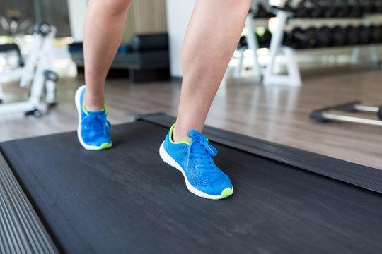 Woman legs on treadmill
