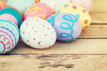 close up colorful easter egg on wood table background.
