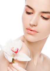 Obraz na płótnie Canvas Beauty fashion model holding white orchid at spa