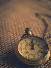 Vintage tone antique pocket watch on wooden background wallpaper in old and retro style with copy space