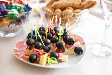 sandwiches from olives cheese and sausages on skewers