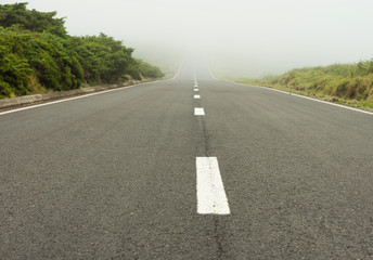 Scenic endless foggy road on Flores island on Azores 