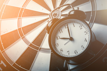 dartboard and black alarmclock with business stretegy ideas concept