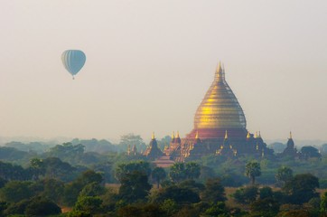 Hot air balloon over Temple in Bagan, misty sunrise at morning, Myanmar.