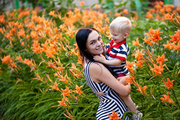 Little boy at mother on hands laughing and indulging