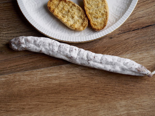 Fuet - Spanish sausage - on wood background