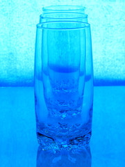 three glasses in a row, toned in blue, shallow depth of field