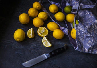Ripe lemons in bag with knife