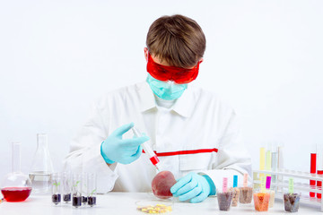 Scientist holding gmo plant for testing in biolaboratory. Injecting the peach