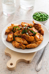 Fried chicken fillet with green peas