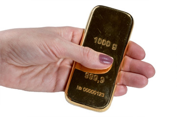 Gold bar in hand isolated on white background.