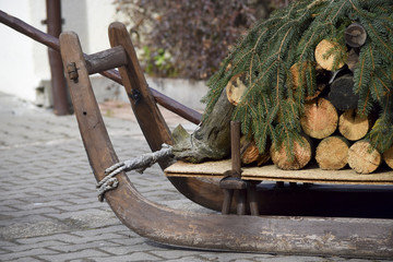 Christmas sleigh with firewood and pine branches