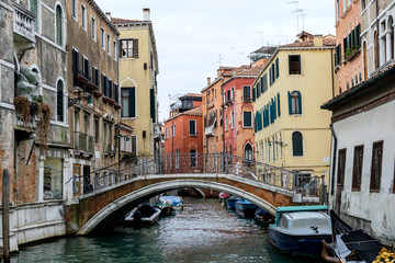 Fototapeta na wymiar View of a canal with a bridge in Venice, Italy
