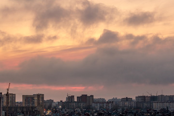 Dramatic aerial sunset cityscape from rooftop of Voronezh city with houses