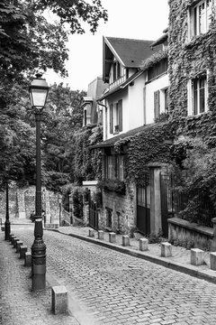 Charming old street of Montmartre hill in black and white. Paris, France