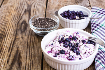Obraz na płótnie Canvas Cottage cheese with berries and chia seeds in white bowl