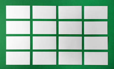 Blank business cards on green background