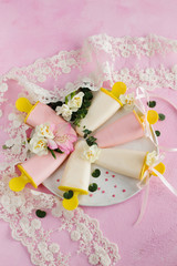 Yoghurt ice cream, decorated with flowers on a pink background