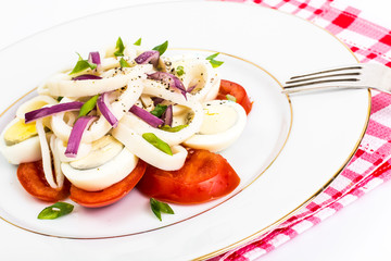 Seafood salad with squid on white background