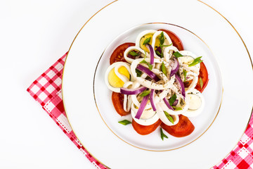 Seafood salad with squid on white background