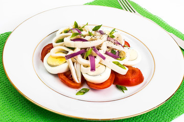 Seafood salad with squid on white background