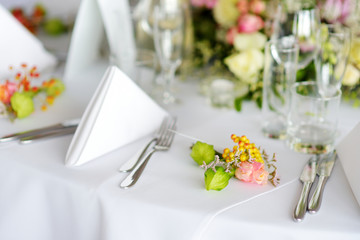 Beautiful table setting with crockery and flowers for a party, wedding reception or other festive event