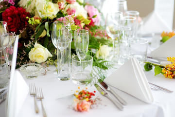 Beautiful table setting with crockery and flowers for a party, wedding reception or other festive event