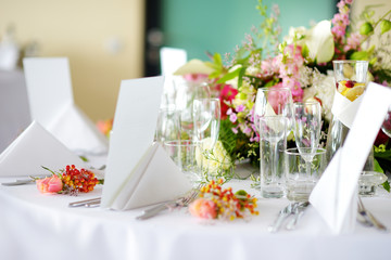 Beautiful table setting with crockery and flowers for a party, wedding reception or other festive...