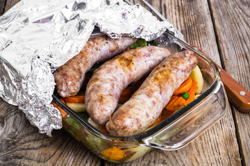 Country sausage with vegetables baked in the shape of glass