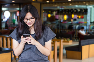 Woman with glasses using phone