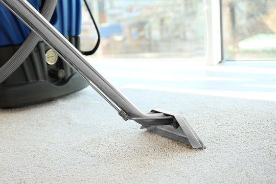 Steam vapor cleaner removing dirt from carpet in flat