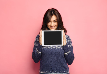 Casual young woman showing a clean tablet screen