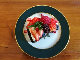 chocolate cake liquid cheese top with mix berry, tea time ,top view