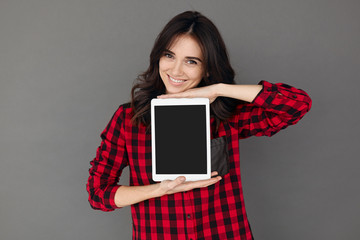 Casual happy Woman Showing Digital Tablet With Blank Screen