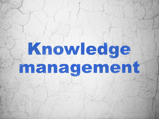 Learning concept: Knowledge Management on wall background