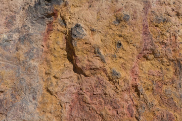 Textured surface of colorful rock