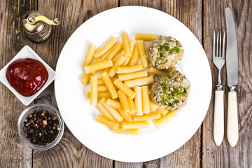Pasta with meatballs and ketchup for lunch
