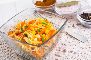Vegetable salad with corn in a glass salad bowl