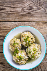 Meatballs meat with the rice grains in a blue ceramic bowl